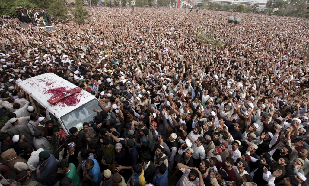 People crowd around the ambulance carrying the body of Mumtaz Qadri during his funeral in Rawalpindi. Photograph: Faisal Mahmood/Reuters